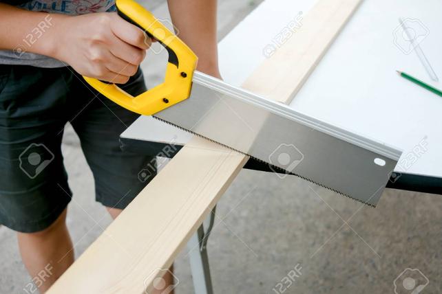 Name:  63690164-carpenter-working-on-a-hand-saw-cutting-wood-board.jpg
Views: 401
Size:  32.2 KB